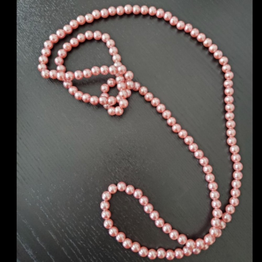 Long strand of faux pink pearls